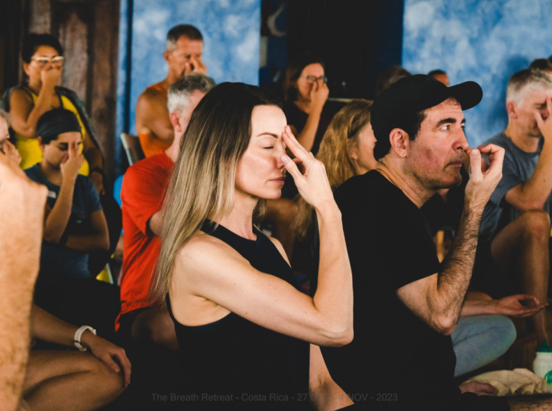 Group breathwork session with participants in meditation